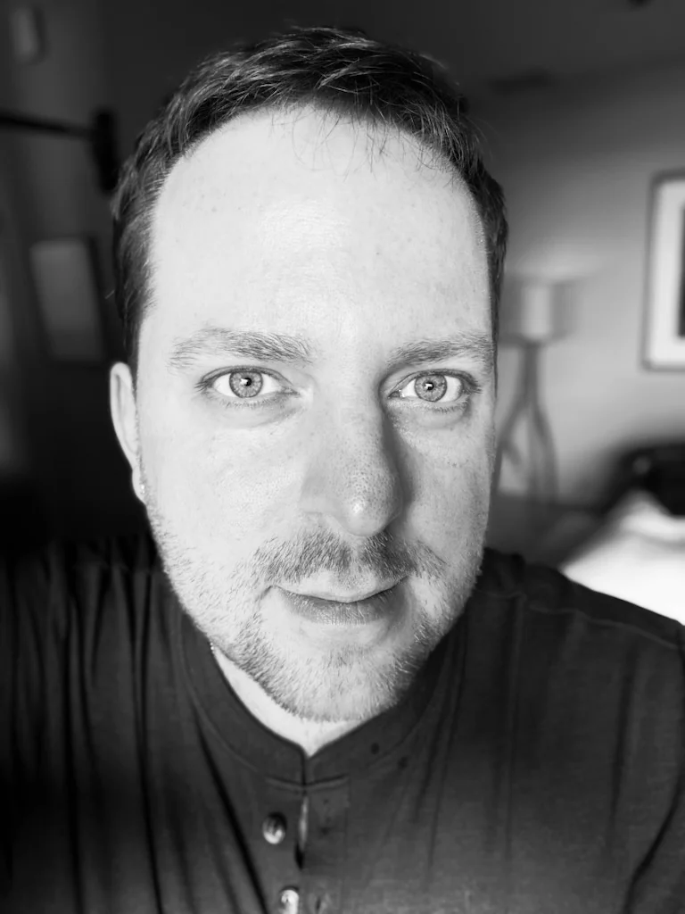 Black-and-white portrait of Robert Fleming in a relaxed indoor setting
